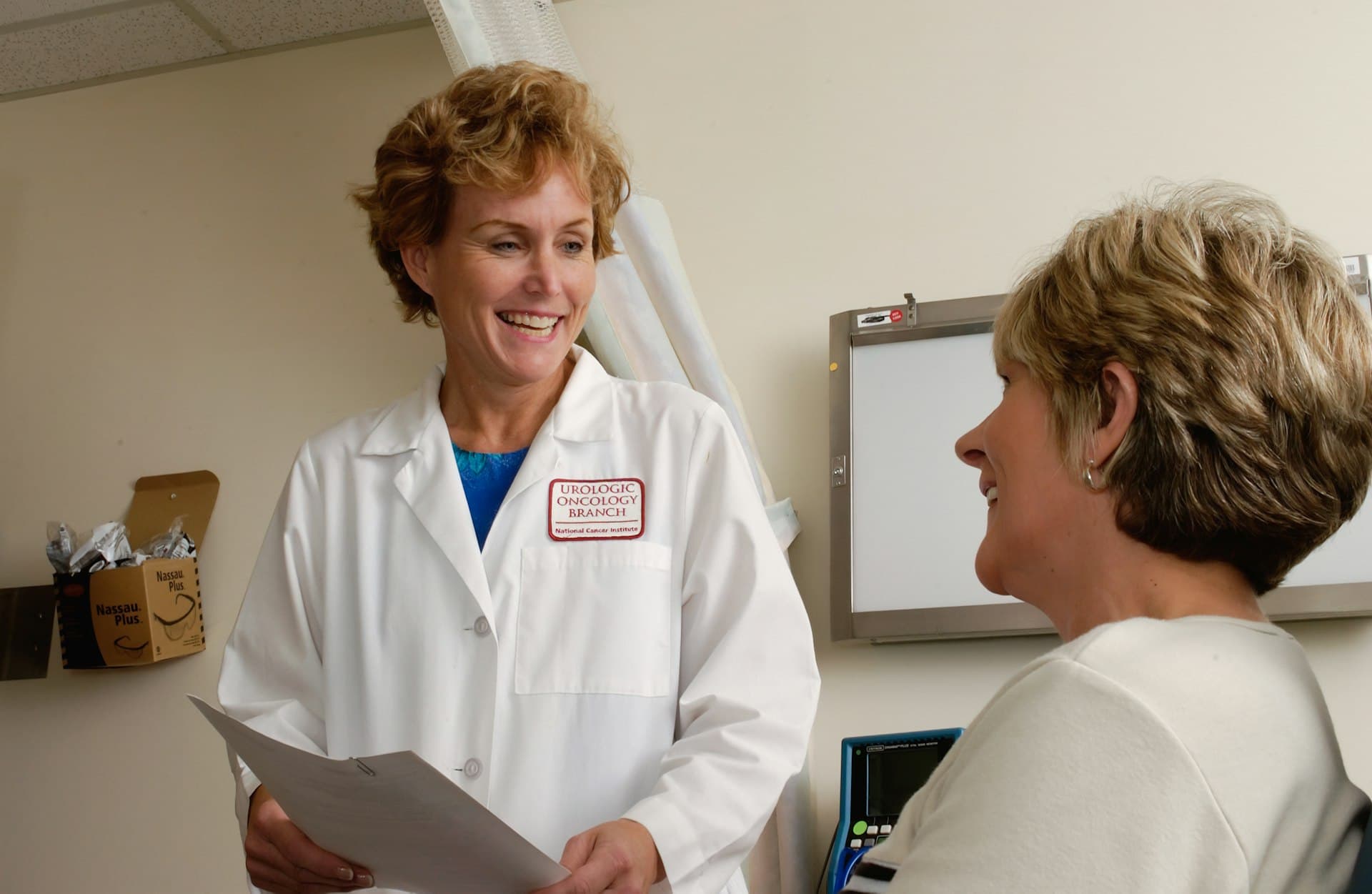 A clinician reviewing health records with a patient during a consultation